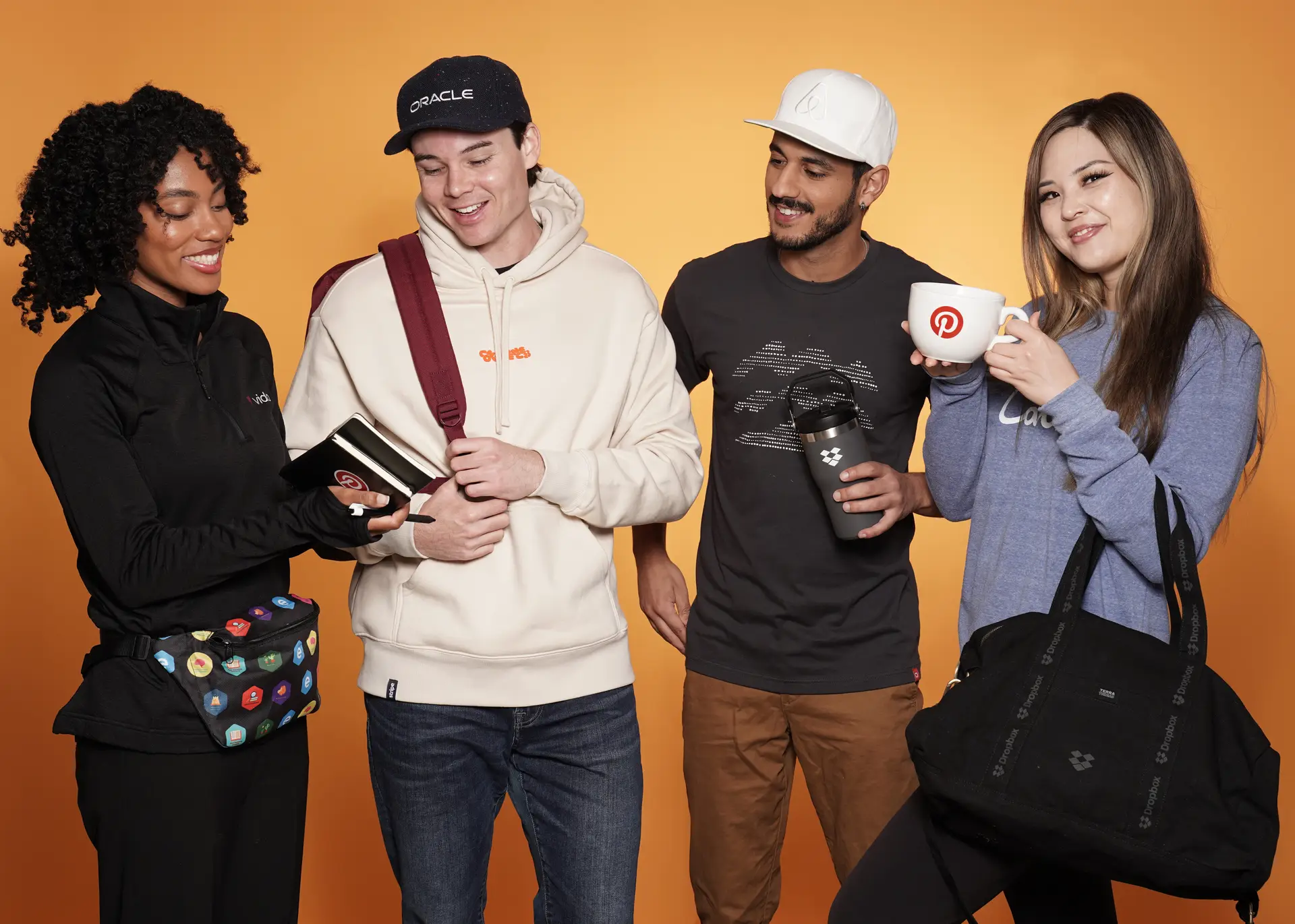 Group with branded merchandise including mugs and bags