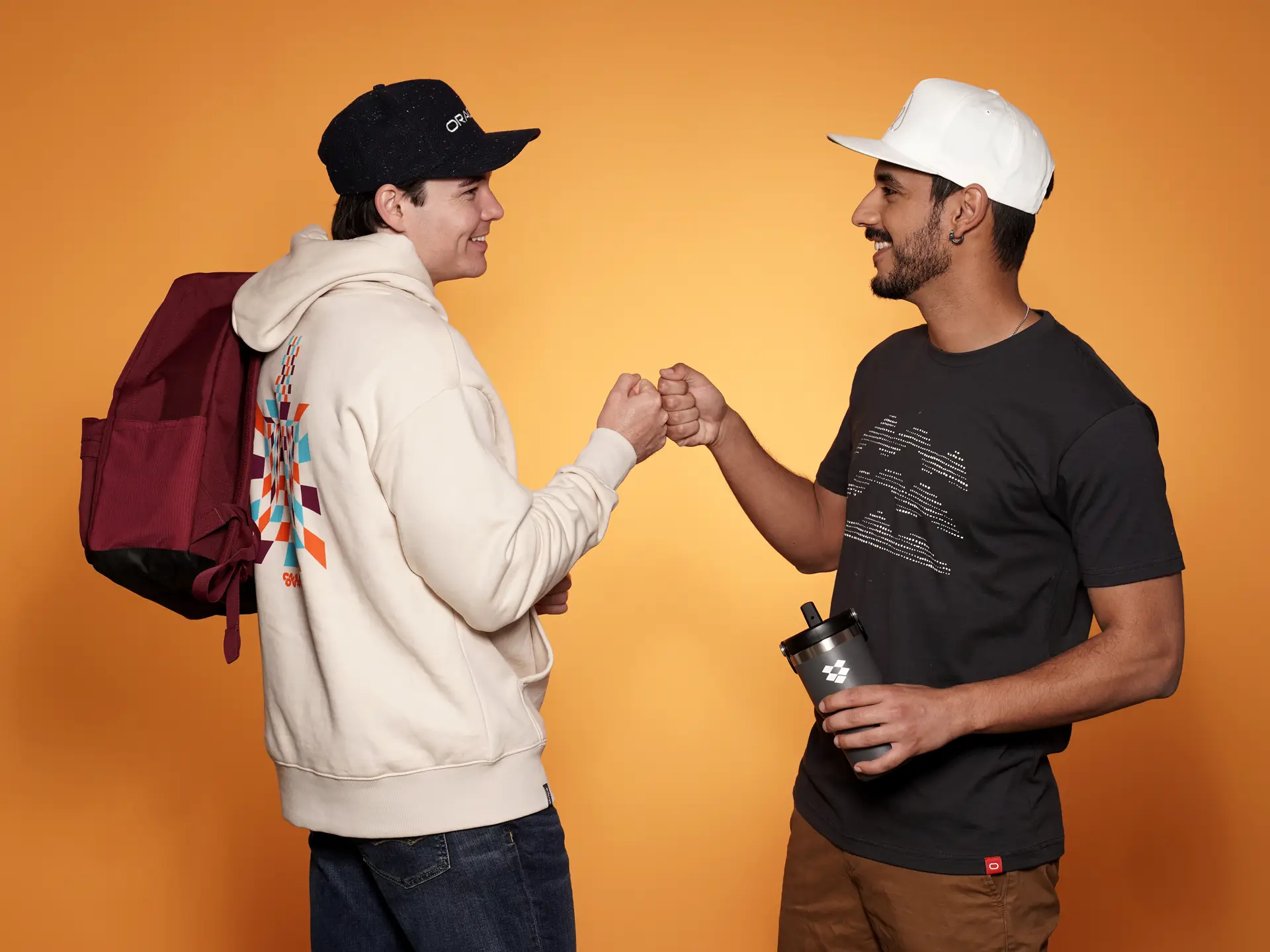 Two men fist bumping, custom branded clothing
