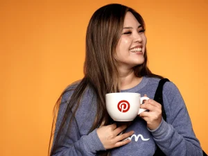 Woman holding custom branded mug and smiling