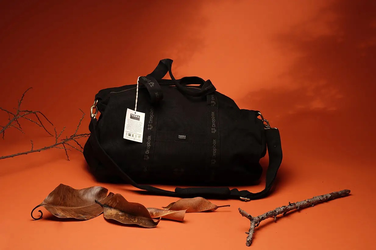 Black duffel bag with tag, autumn decor