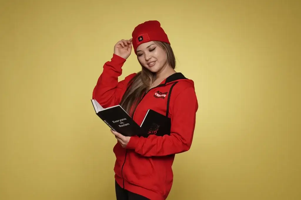 Woman in red outfit reading branded notebook