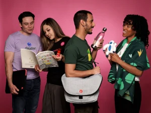 Group displaying branded bags and plush toy