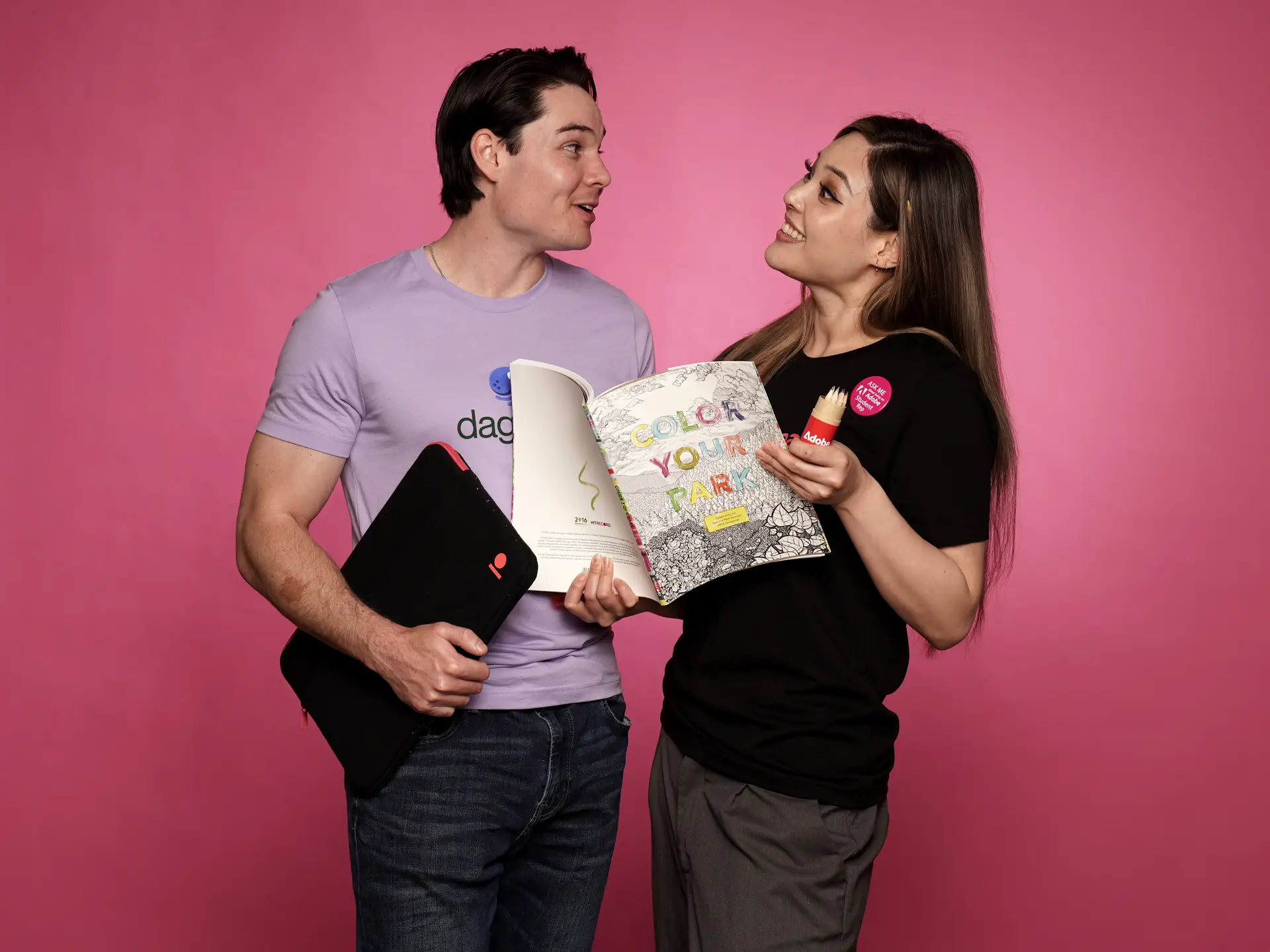 Colleagues with custom branded coloring book and laptop sleeve