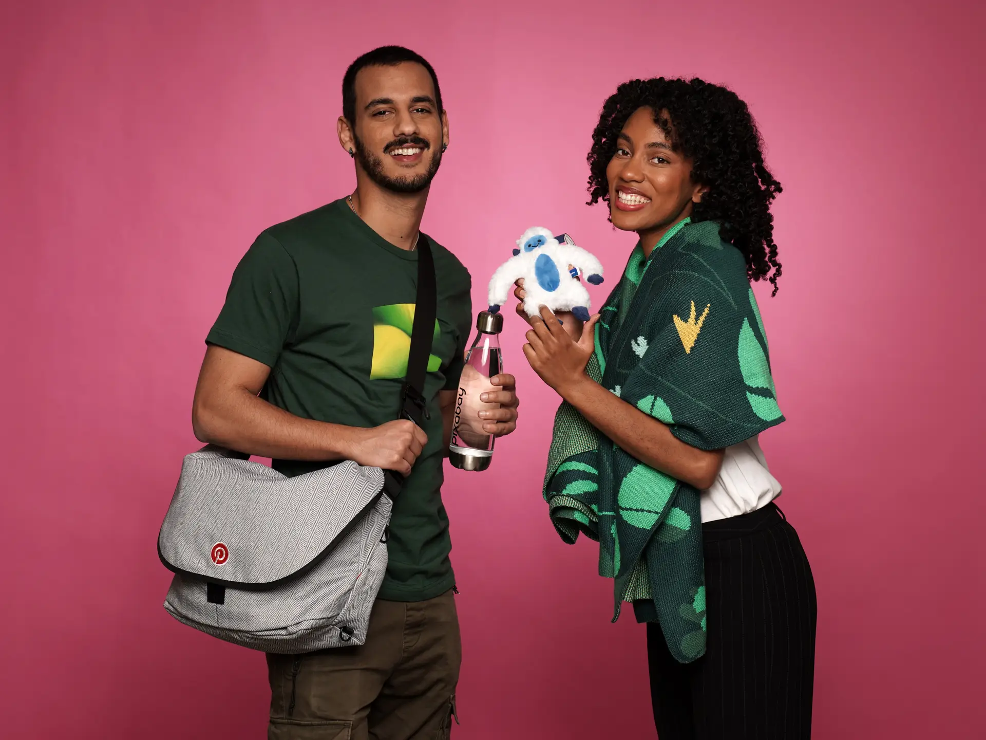 Couple showcasing plush toy and branded products
