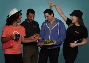 Colleagues sharing grapes and promotional products