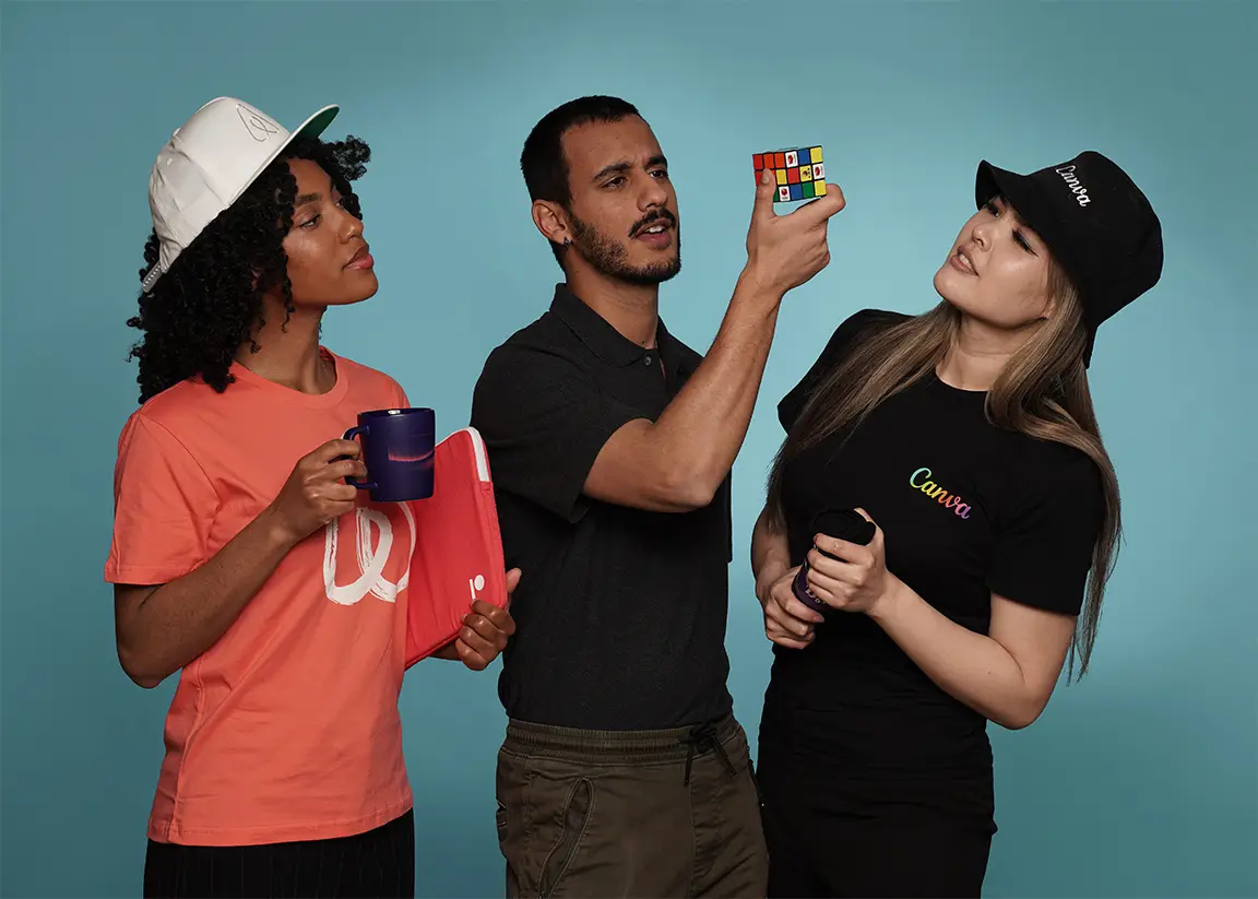 Group with branded Rubik's cube and mugs