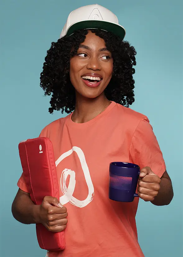 Woman smiling with branded mug and laptop sleeve