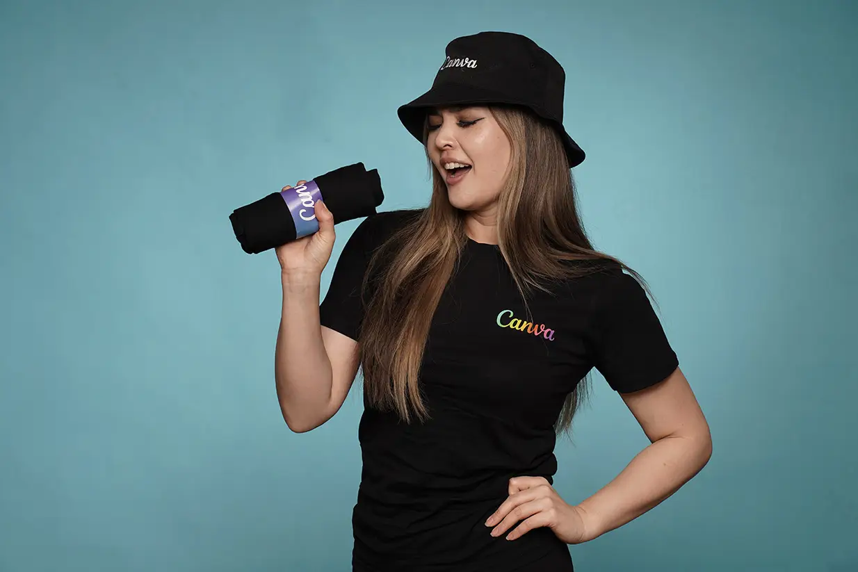 Woman posing with Canva branded merchandise