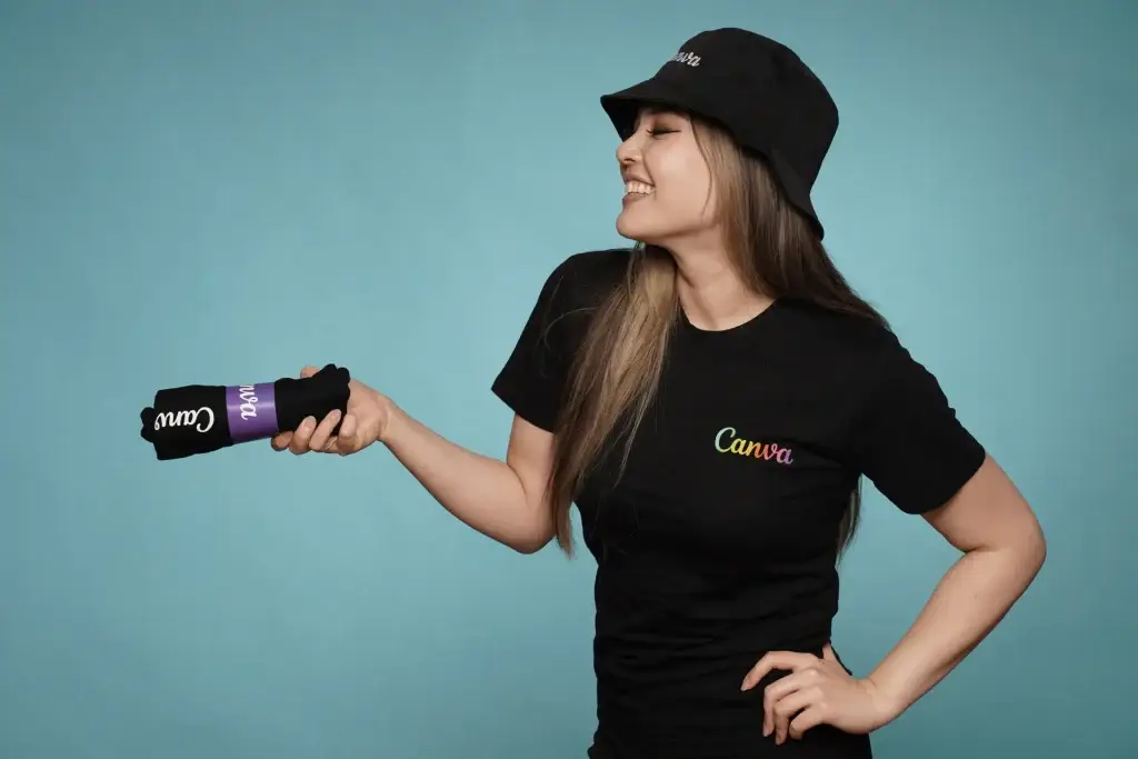 Woman in Canva attire holding rolled shirt