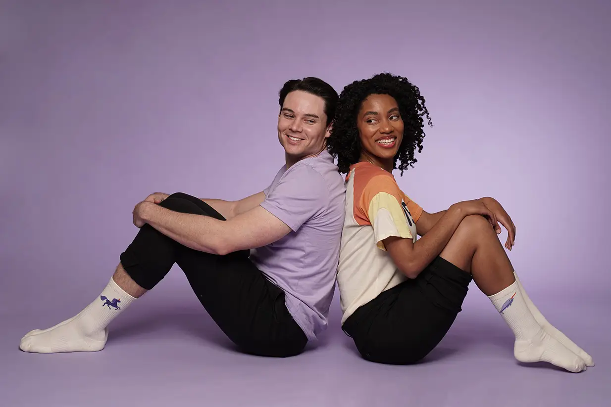 Smiling duo in custom socks and casual attire