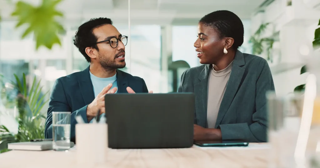 Colleagues discussing business project in office