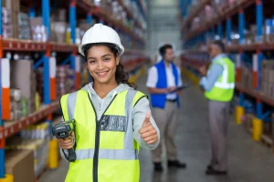 Female warehouse worker giving thumbs up