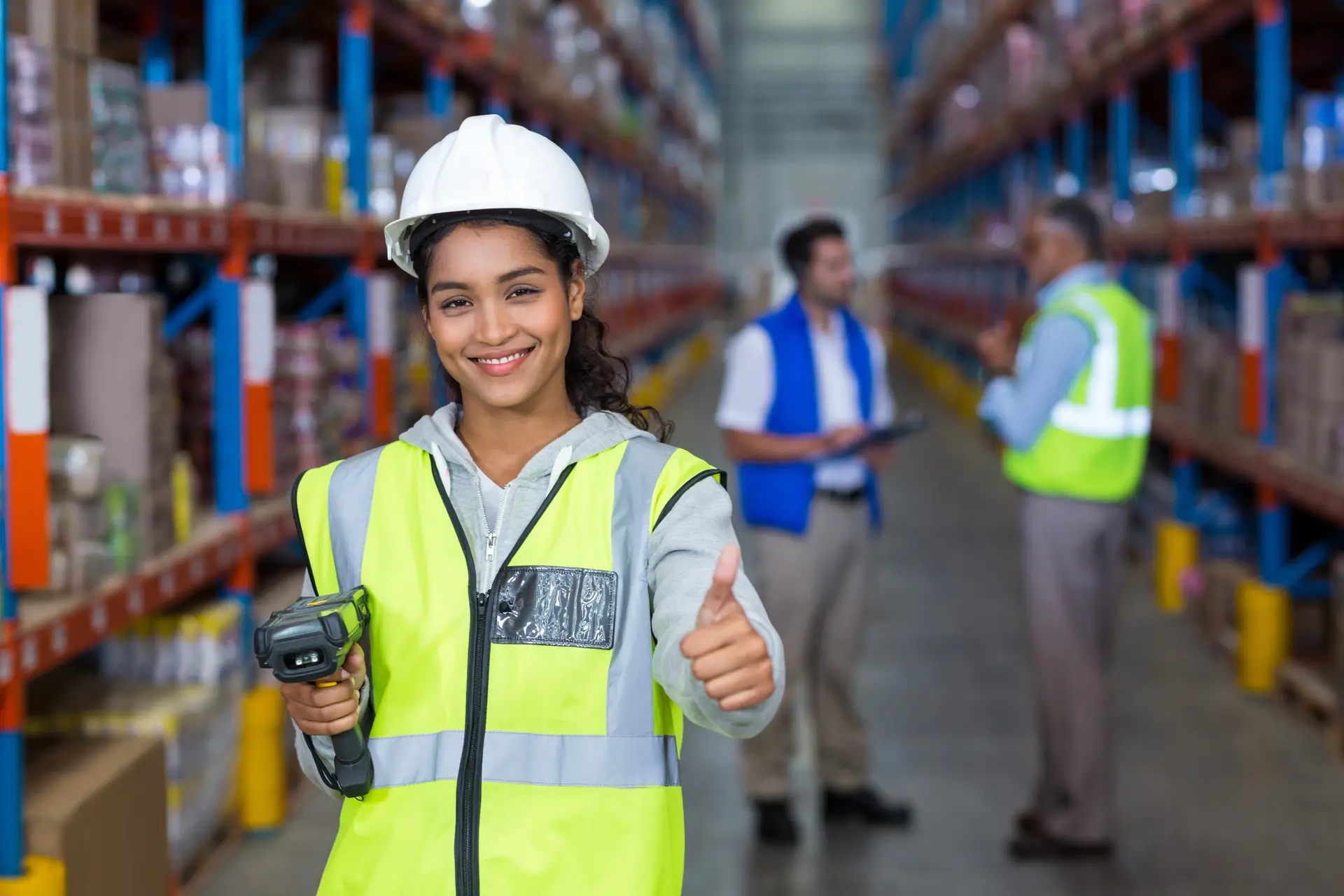Female warehouse worker giving thumbs up