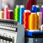 Colorful thread spools on spinning machine