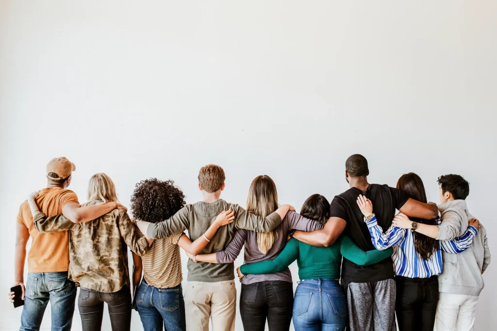 Group of people supporting each other with arms around