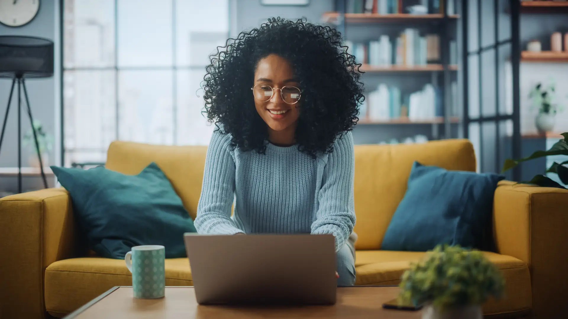 Woman working on laptop in cozy home setting
