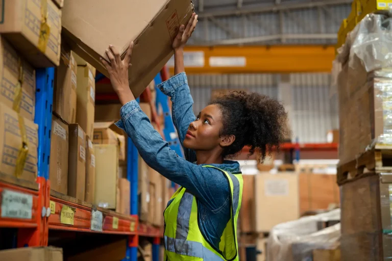 Woman organizing products in warehouse