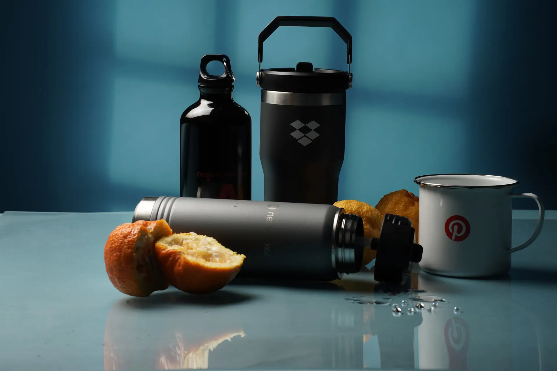 Custom branded promotional drinkware including insulated tumblers, water bottles, and enamel mugs with company logos, ideal corporate swag and sustainable giveaway items for events.