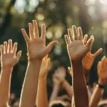 Raised hands at an outdoor event symbolizing engagement and participation, ideal for corporate swag, event giveaways, and promotional products by top swag companies.