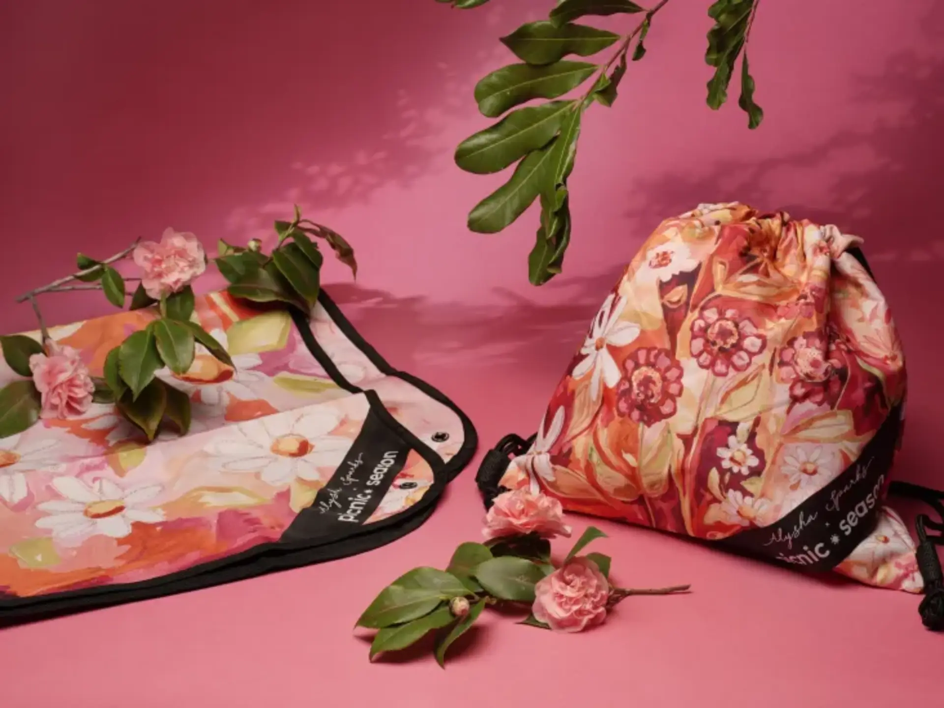 Floral custom drawstring bag and matching picnic blanket with vibrant pink and orange design, eco-friendly promotional products for corporate swag and event giveaways.