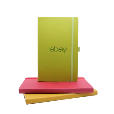 Stack of custom branded notebooks with eBay logo, showcasing promotional products for corporate swag, employee gifts, and event giveaways.