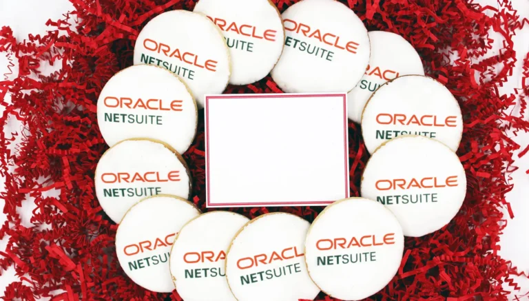 Custom branded Oracle NetSuite logo cookies arranged in a gift box with red shredded paper, showcasing personalized corporate gifts and promotional products for events.