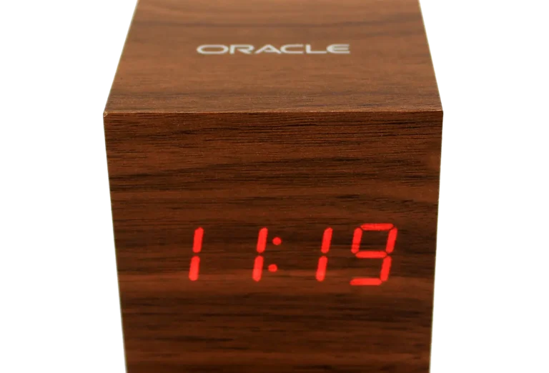 Wooden digital clock branded with Oracle logo, ideal corporate gift or promotional product for events and employee recognition.